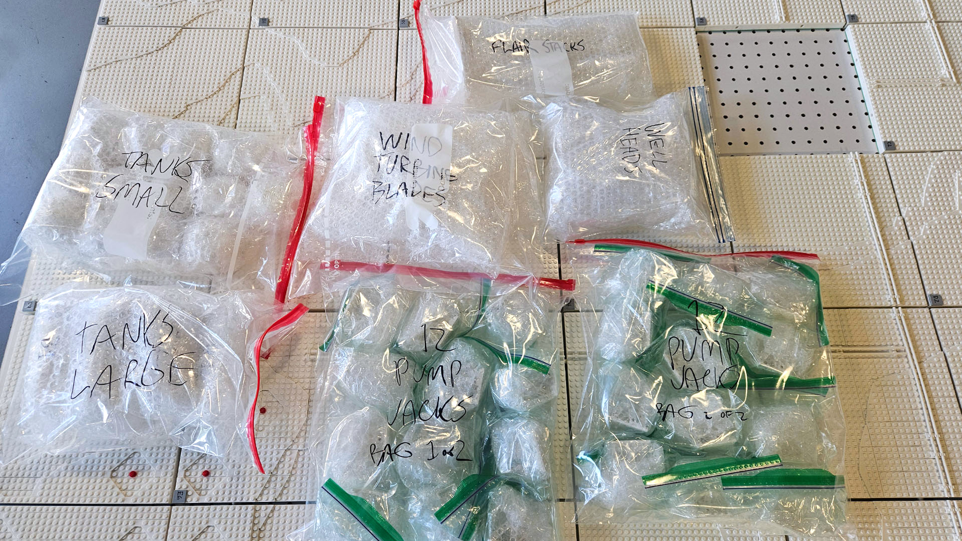 Modular sections of the LEGO installation being packed and labeled for shipment to Beijing